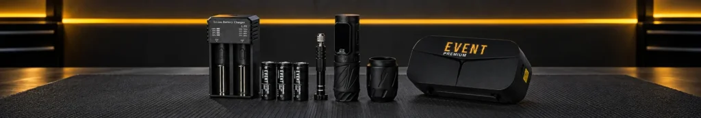 AI-generated image of tattoo studio equipment laid out on a black mat: battery charger, batteries, machine, grip and carry case under amber lighting